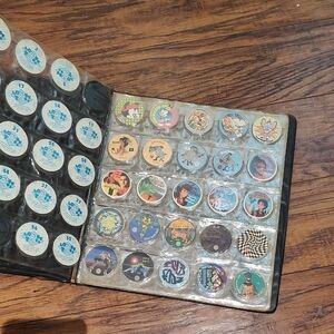 Vintage Collectible Pogs in Black Binder